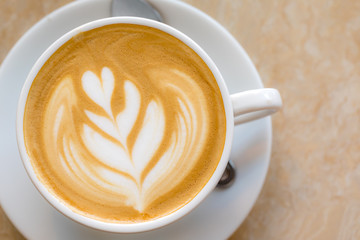 Top view of Hot Latte coffee with white cup and a spoon