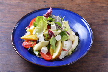 Fresh fruit salad in a blue plate   