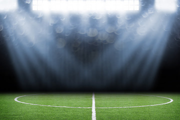 Fototapeta premium Soccer ball on field in stadium at night