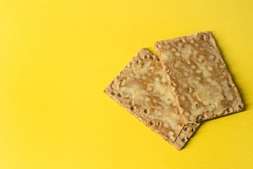 Close-up of rye crackers with butter - on bright green background - minimal- copy space