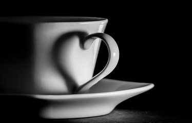 coffee cup; the handle of the cup silhouettes a heart