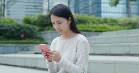 Woman working on cellphone at outdoor