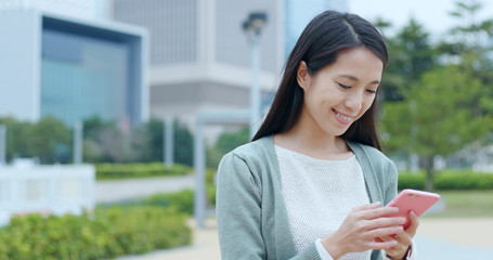 Woman use of smart phone at outdoor © leungchopan