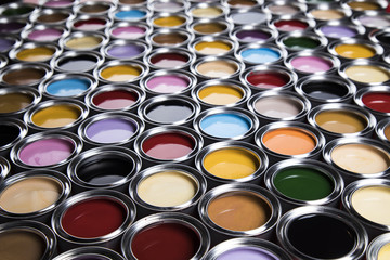 Buckets full of rainbow colored oil paint