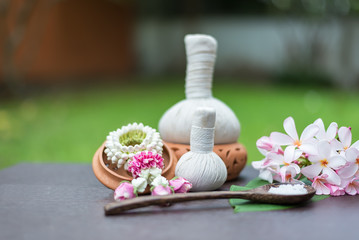 Obraz na płótnie Canvas Spa massage compress balls, herbal ball on the wooden with treaments spa , Thailand, soft and select focus.