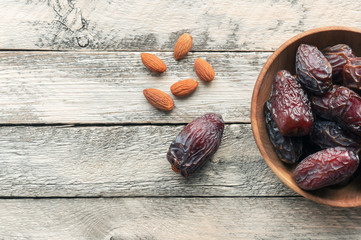Medjool Dates and almond on wooden background with copy space. Top view. 