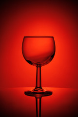 Fototapeta na wymiar Glass for wine in red lighting on a table