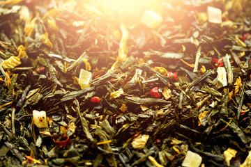Texture of green tea with dried petals of blue flowers, calendula, cornflower. Food background. Organic healthy herbal leaves, detox tea.
