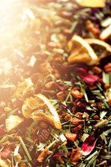 Mix tea karkade with dried fruits and flowers. Fruit tea background and texture. Top view. Food background. Organic healthy herbal leaves, detox tea.