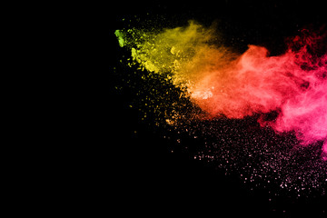 Abstract art colored powder on black background. Frozen abstract movement of dust explosion...