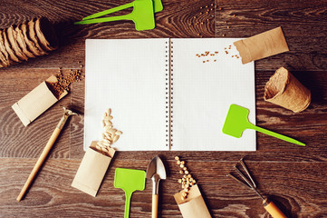 spring garden flat lay with seeds in handmade envelopes, note book, labels and tools. Seeding...