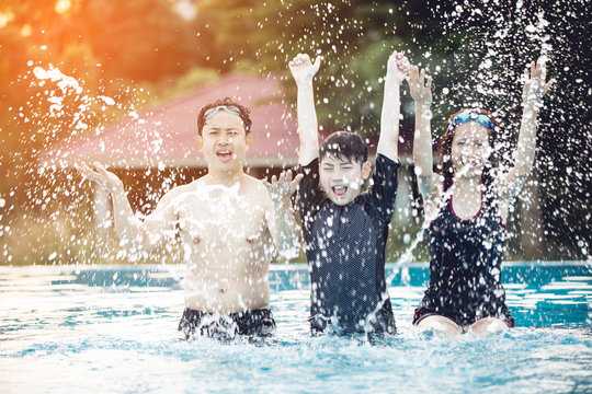 Portrait of happy Family In Swimming Pool.