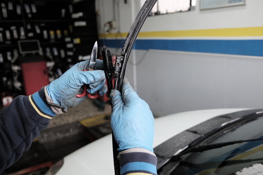 technician replaces wiper blades