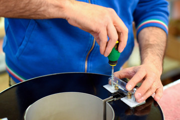 Worker making electric transformers in close up