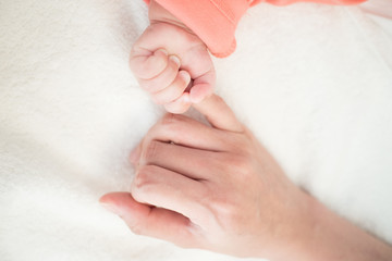 New Born Baby hand hold little finger of mom: concept of love, take care, parent relationship