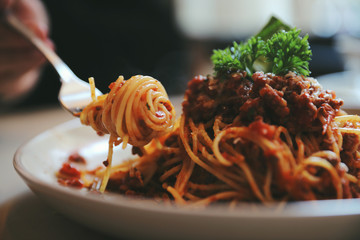 spaghetti Bolognese with minced beef and tomato sauce garnished with parmesan cheese and basil , Italian food - 197444675