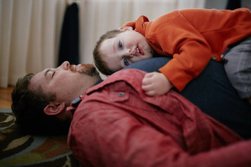 son resting on fathers chest