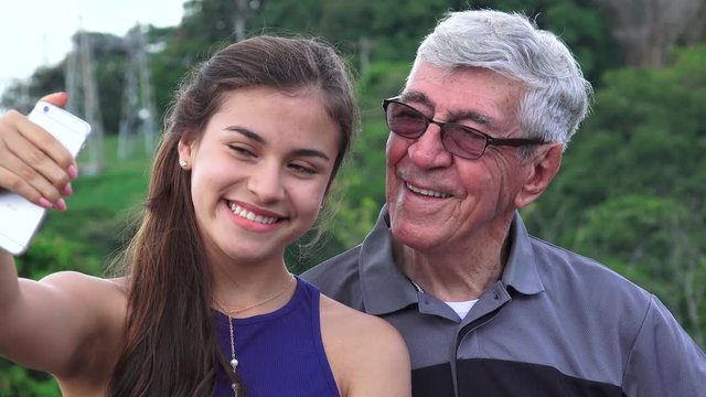 Selfie Of Hispanic Grandfather And Granddaughter