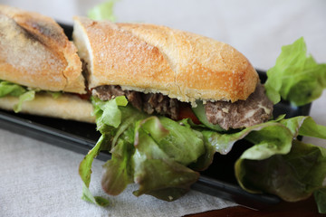 Beef sandwich on wood background