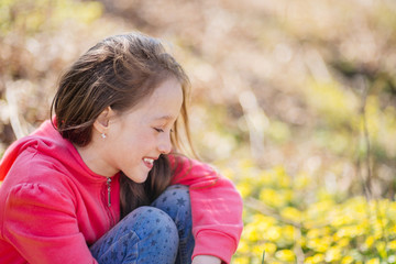 Portrait of the young smiling girl in the spring wood.