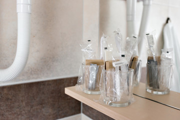 Close up view on the bottles with cosmetics and hygienic kit ain the hotel bathroom