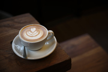Cappuccino coffee cup on wood background