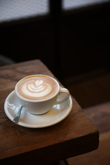 Cappuccino coffee cup on wood background