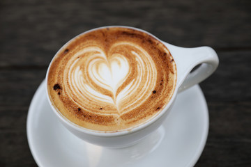 Cappuccino coffee cup on wood background
