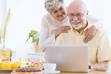 Senior marriage looking on laptop