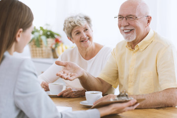 Old couple talking with agent