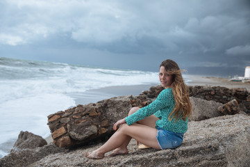 Fototapeta na wymiar Woman sitting looking at the sea
