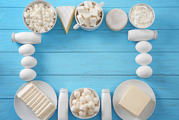 Fresh dairy products and eggs on wooden background