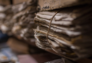 Old dusty stack of papers, files, documents on the shelves of archive room