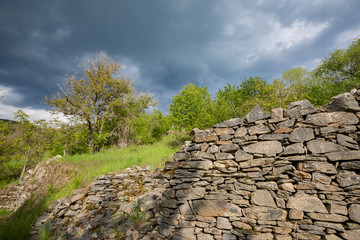 Old Roman stone wall lit by the sun