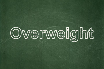 Fototapeta premium Healthcare concept: text Overweight on Green chalkboard background