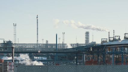 Fototapeta na wymiar Infrastructure of industrial power plant, smoking pipes, pipelines and torch