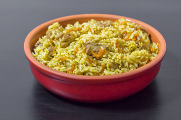 Pilaf with beef, carrots, onions, garlic, pepper and cumin. A traditional dish of Asian cuisine.