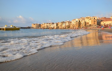 Cefalù, Italy, Sicily August 16 2015 Cefalù beach. It is possible to take a bath admiring the old town overlooking the sea, the fortress of Cefalù overlooking the sea, tourists from all over the world