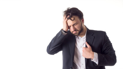 Close up portrait of a young bearded man suffering from a strong headache isolated over white background