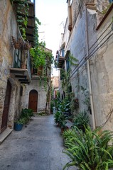 Fototapeta na wymiar Monreale, Italy, Sicily August 20 2015. The alleys of Monreale, vases in bloom, small balconies, views of the village. Small houses.