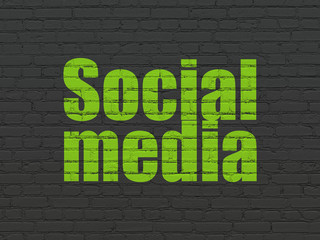 Social media concept: Painted green text Social Media on Black Brick wall background