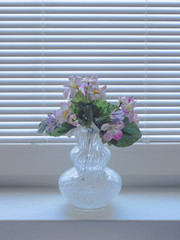 Glass vase with artificial flowers