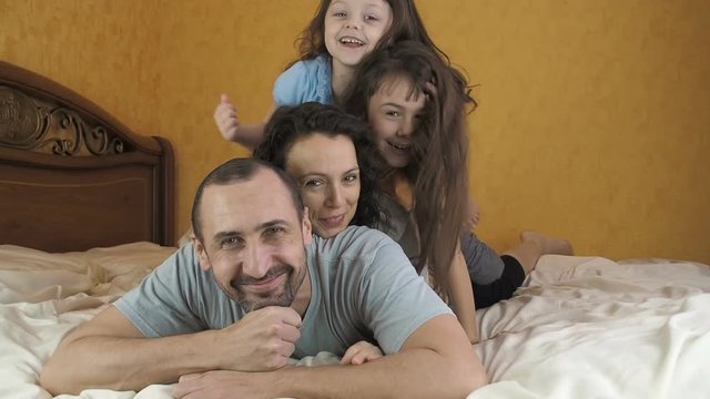 A cheerful family in the bedroom.
