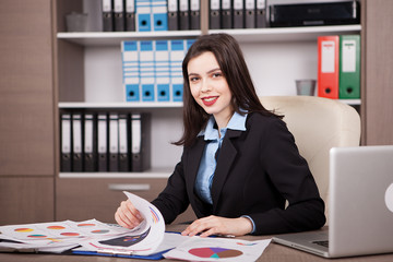 Female businesswoman in formal suit in her office