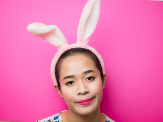 Obraz na płótnie Canvas Woman wearing bunny ears headband during Easter.