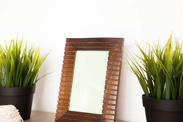 Side view of wooden photo frame over white wall