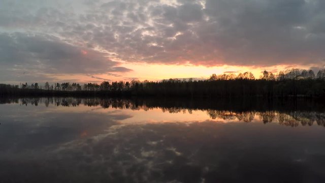 HD time-lapse beautiful sunset on the lake. Sunset at the lake. Forest in the background.