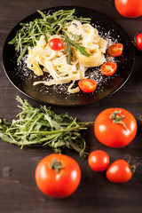 Mozzarella cheese with tagliatelle pasta on wooden table