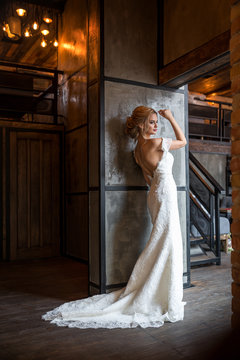 woman in wedding dress posing in luxury interior