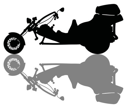 The black silhouette of a heavy motor tricycle